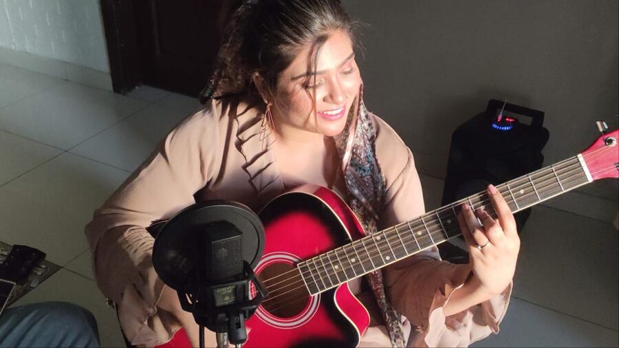 Rubab Fatima behind the scenes with her guitar